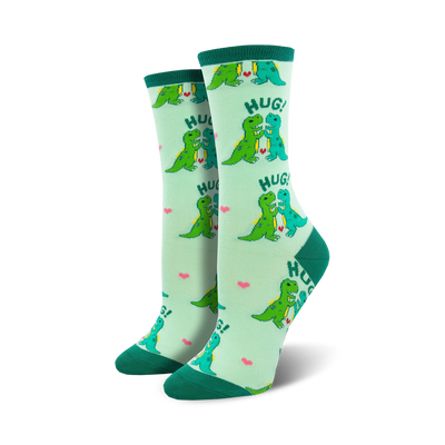 womens crew socks in light green with pattern of cartoon dinosaurs hugging, hearts between. dinosaur theme.  