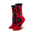 A pair of women's crew socks in red, adorned with a bold black and teal snake design. The snake is depicted in a coiled pattern.