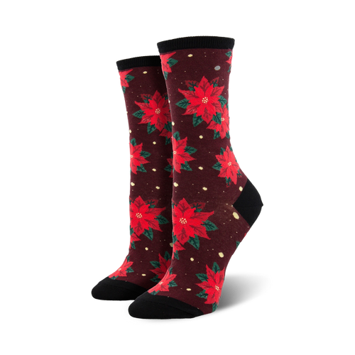 Pair of women's crew socks with red poinsettia flowers on a burgundy background.  Features a black cuff.