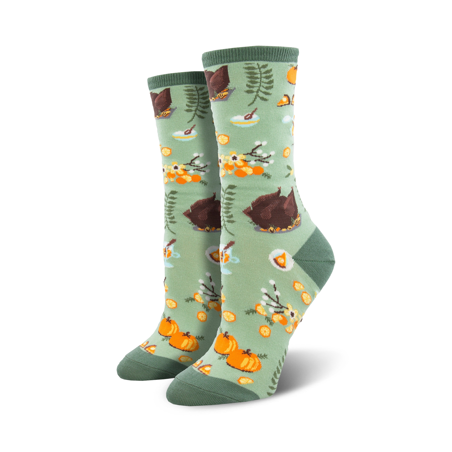 Close-up of a pair of sage green crew socks with the same Thanksgiving pattern as the teal socks.  Focus is on the design details.