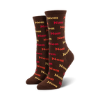 Pair of brown crew socks with a repeating pattern of the word 'Nom' in shades of red, orange, and beige.