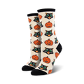 Close-up showing detail of the cream-colored Vintage Halloween socks with black cat and pumpkin design.