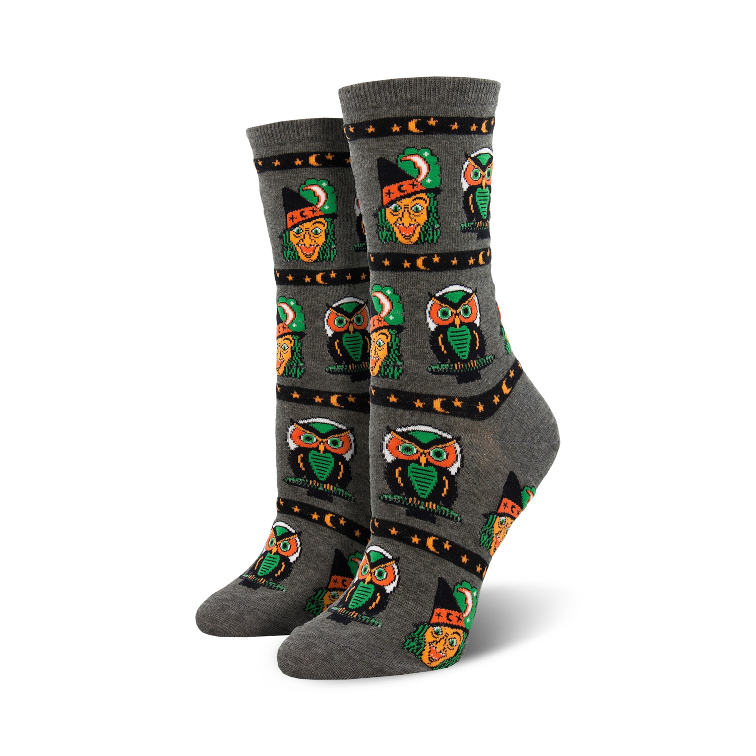 Pair of crew socks in grey and orange, showcasing a repeating pattern of pixel art witches and owls with stars and crescent moons.