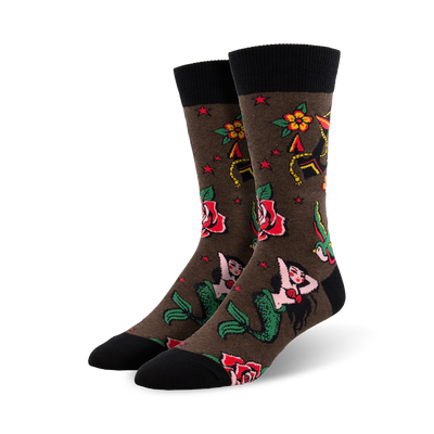 crew length cotton socks feature brown background with traditional tattoo designs like mermaids, roses, stars, and swallows.   