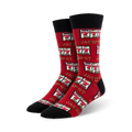 Pair of red crew socks with a black cuff.  The socks are covered in a repeating pattern of slot machine images showing three lucky sevens and the word Jackpot.