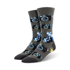 A pair of grey crew socks with a pattern of vintage cameras and lenses in blue and black. 