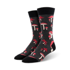 A pair of dark grey crew socks adorned with a scattered pattern of red and white mushrooms. Fun and quirky!