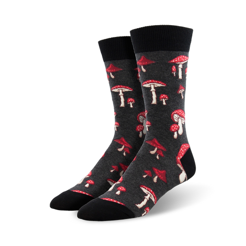 A pair of dark grey crew socks adorned with a scattered pattern of red and white mushrooms. Fun and quirky!