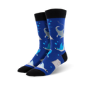 A pair of men's crew socks in blue, adorned with gray manta rays, light-blue stingrays, and white bubbles.  The socks have black cuffs.