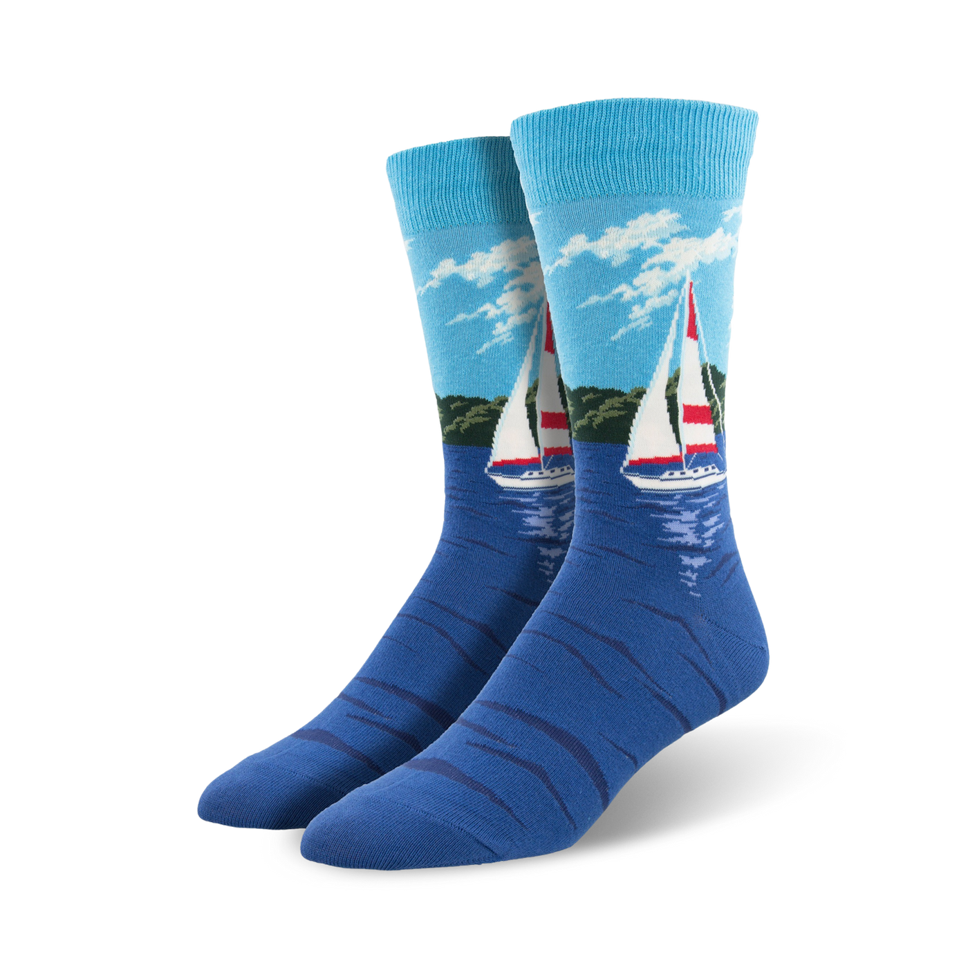 Pair of blue crew socks with a sailboat design on a water scene.  Light blue sky, green shoreline, and a red and white sailboat are featured on a navy blue background.