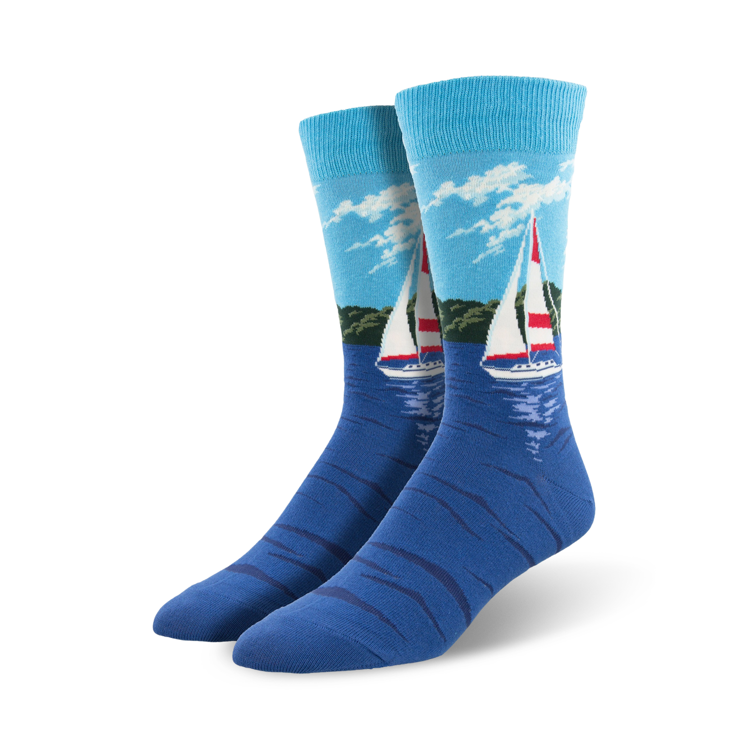 Pair of blue crew socks with a sailboat design on a water scene.  Light blue sky, green shoreline, and a red and white sailboat are featured on a navy blue background.