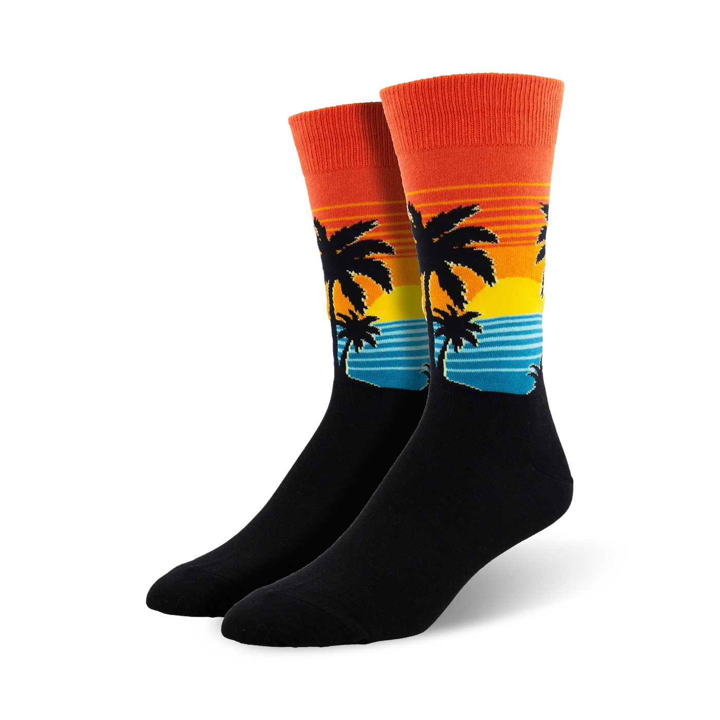 Pair of crew socks with a sunset, palm trees, and ocean wave design.  The socks are mainly black with orange, yellow, and teal accents.