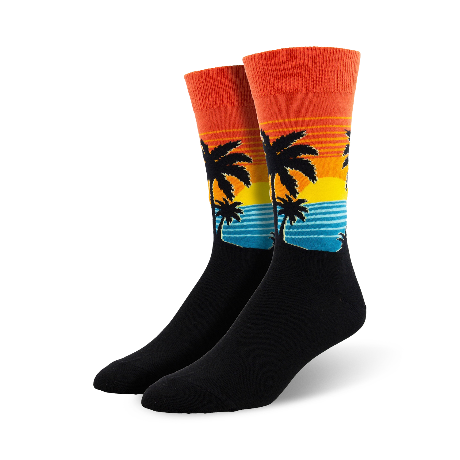 Pair of crew socks with a sunset, palm trees, and ocean wave design.  The socks are mainly black with orange, yellow, and teal accents.
