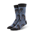 Pair of crew socks in blue with a pattern of black French Bulldogs and small brown paw prints. The socks have dark gray cuffs.
