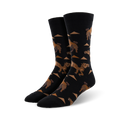 A pair of black crew socks with a repeating pattern of brown camels and tan triangles. Fun and quirky.