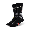 Pair of black crew socks with a skull, rocket, and spaceship design against a space-themed background.