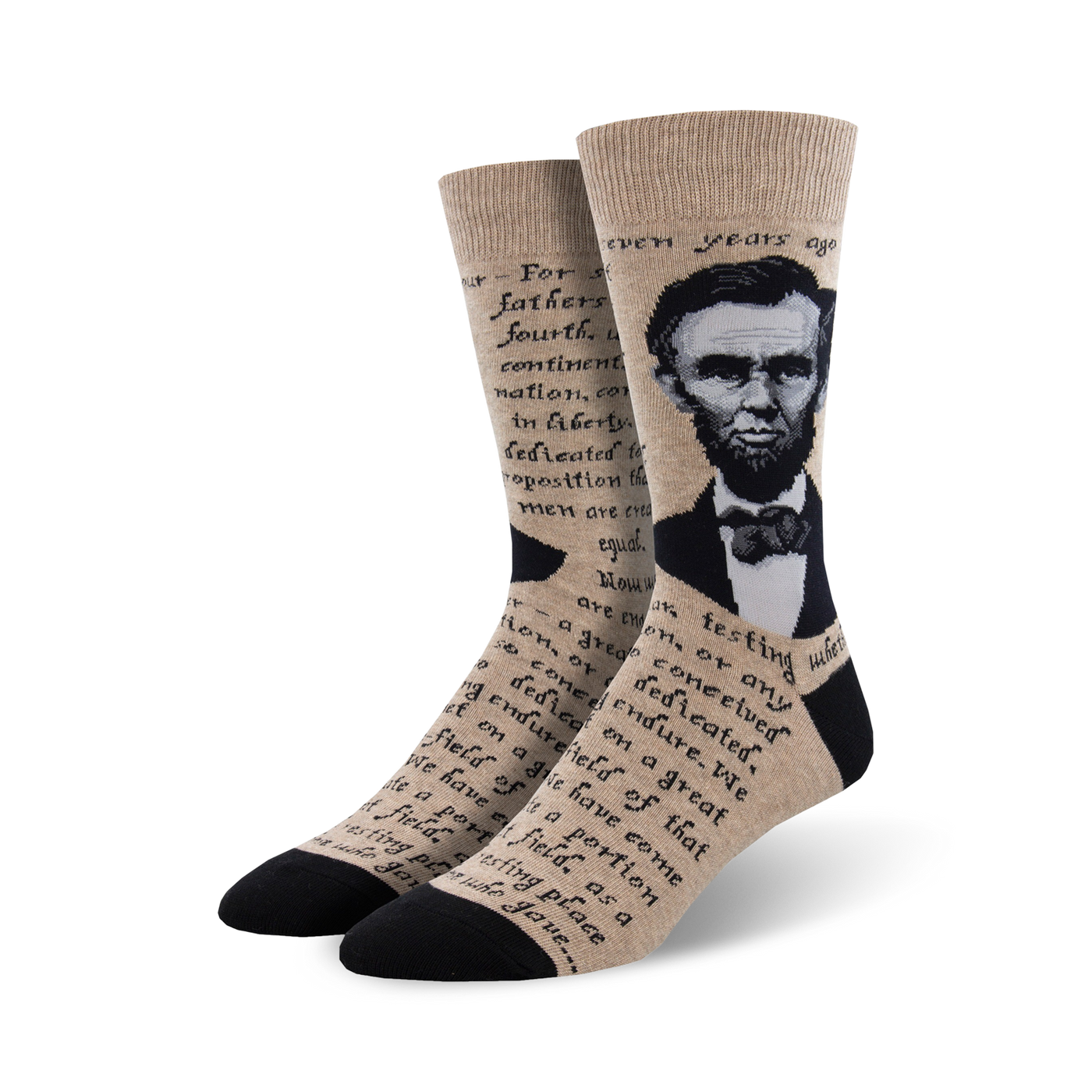 Crew socks in beige and black, featuring a portrait of Abraham Lincoln and text from the Gettysburg Address.