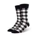 Close-up studio shot of black and white buffalo plaid crew socks.