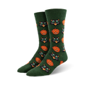Pair of crew socks in dark green featuring a repeating pattern of grinning jack-o'-lanterns and black cats with bright green eyes.