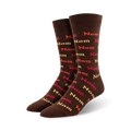 Pair of brown crew socks with a repeating pattern of the word 'nom' in orange, red, and beige.