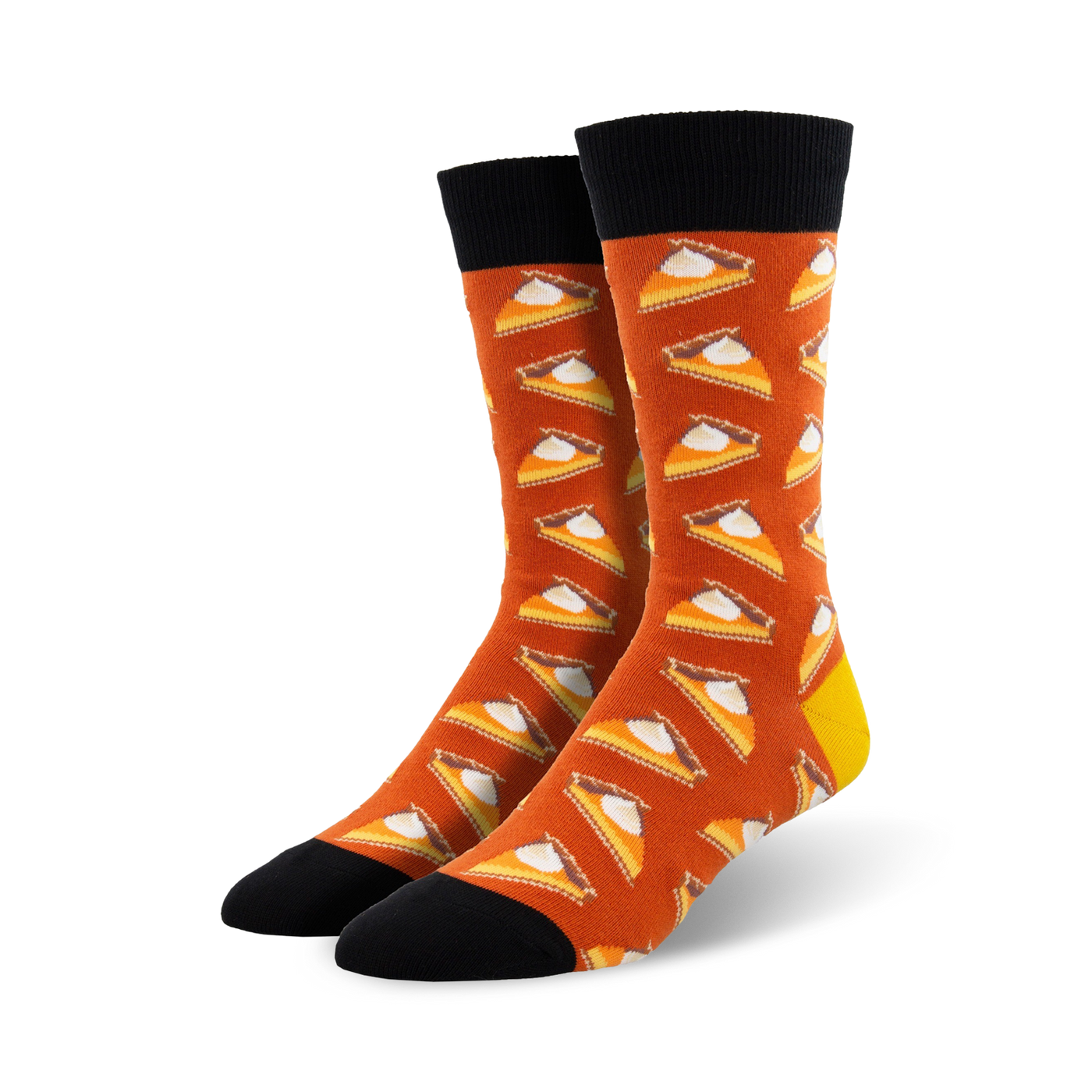 A pair of crew socks in burnt orange with a repeating pattern of pumpkin pie slices. The socks have black cuffs and yellow heels.