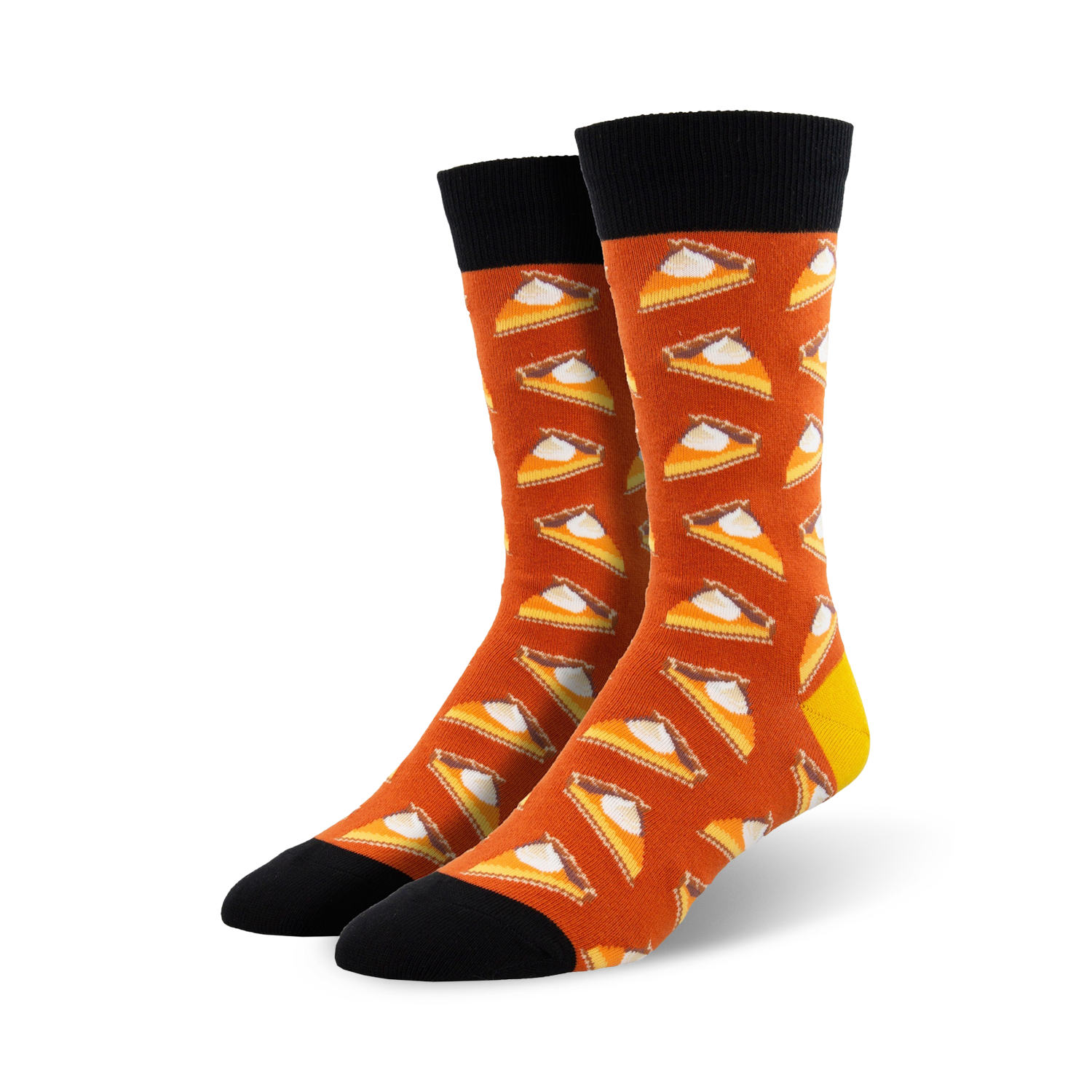 A pair of crew socks in burnt orange with a repeating pattern of pumpkin pie slices. The socks have black cuffs and yellow heels.