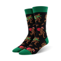 Pair of crew socks; black background with Bigfoot carrying a Christmas tree and Santa sack; green cuffs; red and green accents.