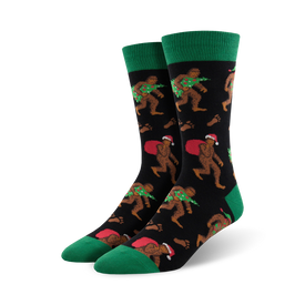 mens crew socks with christmas bigfoot pattern, santa hat, presents, wreath, black, green.    