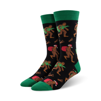 mens crew socks with christmas bigfoot pattern, santa hat, presents, wreath, black, green.    