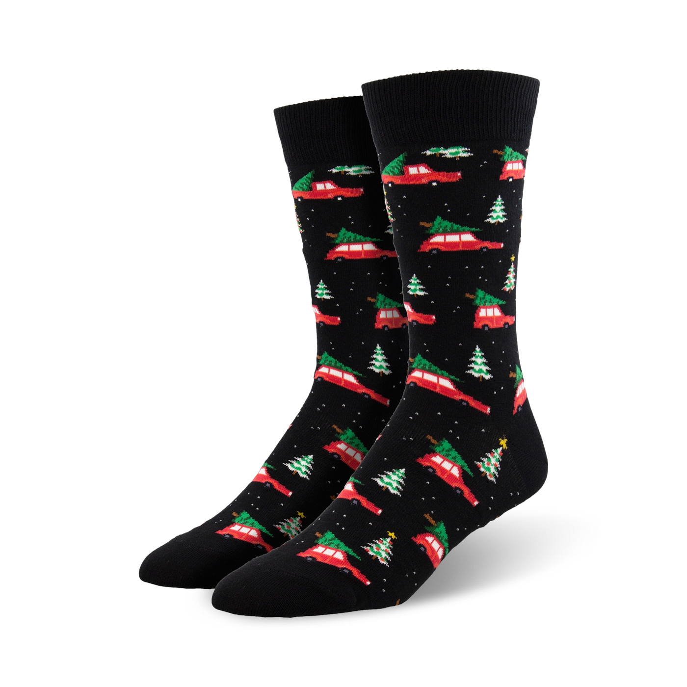 A pair of black crew socks with a pattern of red cars carrying Christmas trees and small green trees. Festive and fun!