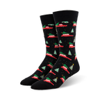 A pair of black crew socks with a pattern of red cars carrying Christmas trees and small green trees. Festive and fun!