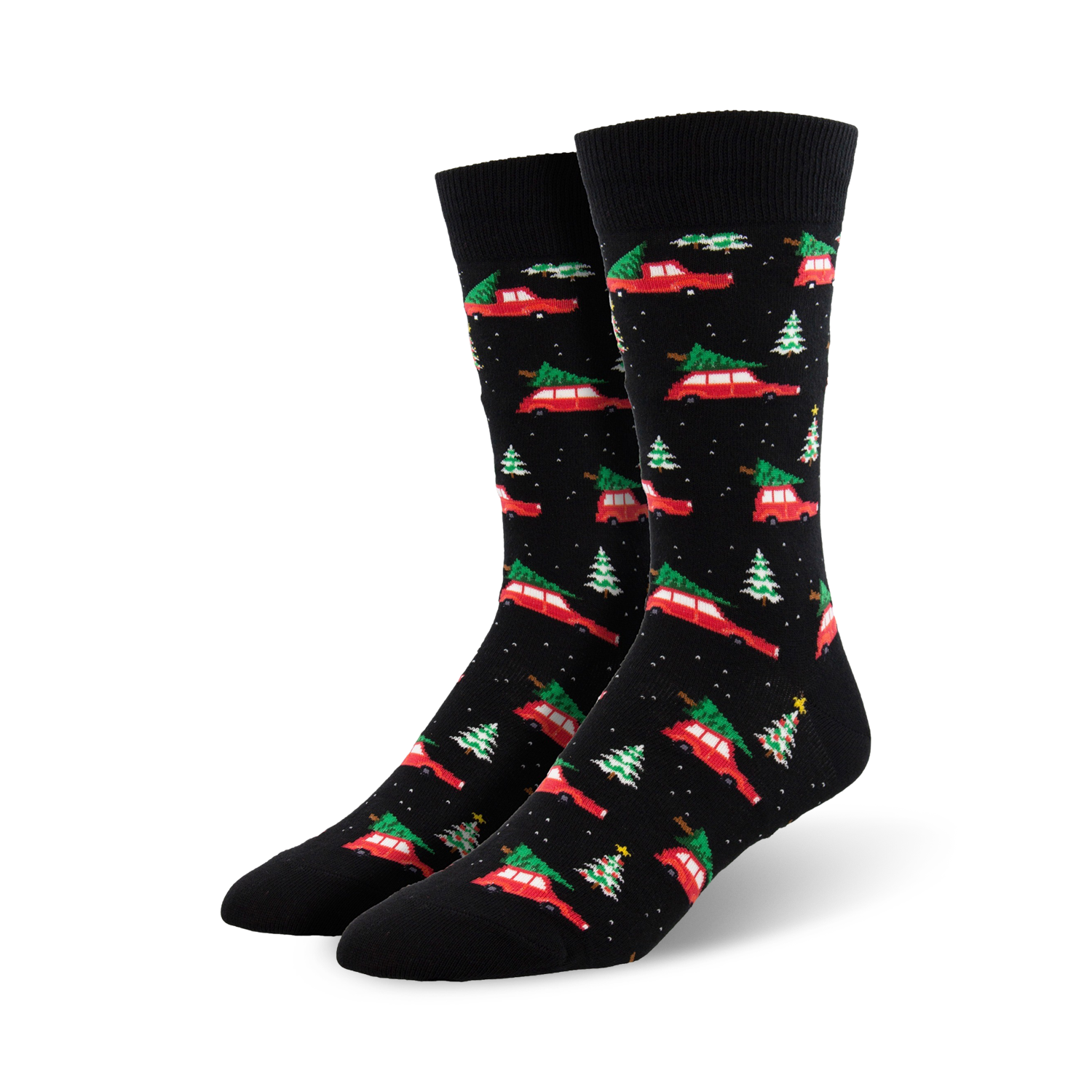 A pair of black crew socks with a pattern of red cars carrying Christmas trees and small green trees. Festive and fun!