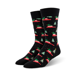 A pair of black crew socks with a pattern of red cars carrying Christmas trees and small green trees. Festive and fun!
