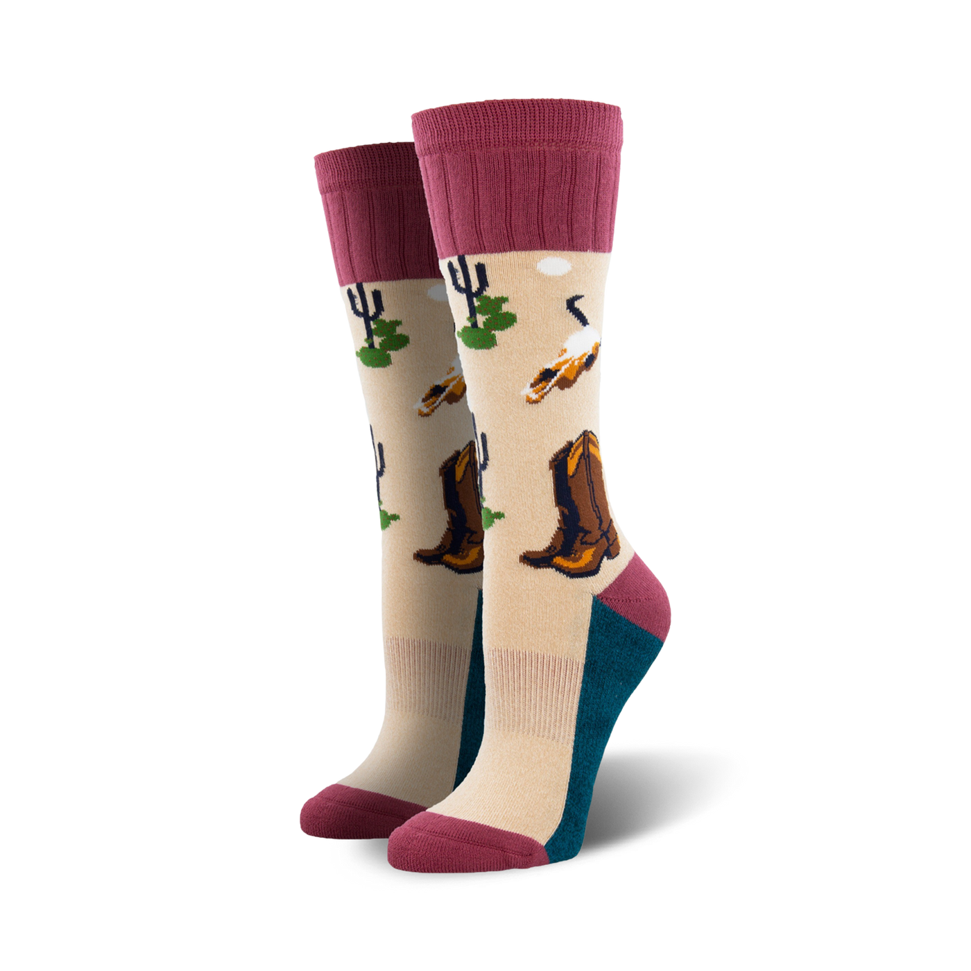 A pair of beige crew socks with maroon cuffs. The socks feature a desert landscape design with cowboy boots, cacti, and birds.