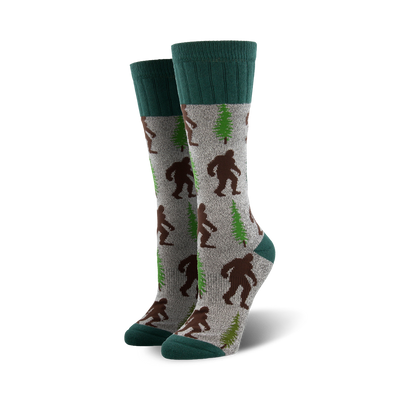 gray boot socks featuring brown bigfoot creatures and green pine trees