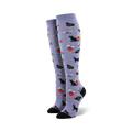 Pair of women's knee-high socks in periwinkle blue. The socks feature a whimsical design of black cats, chickens, and flowers in red pots.