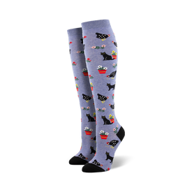 blue knee-high women's socks with a pattern of black cats and red chickens.  