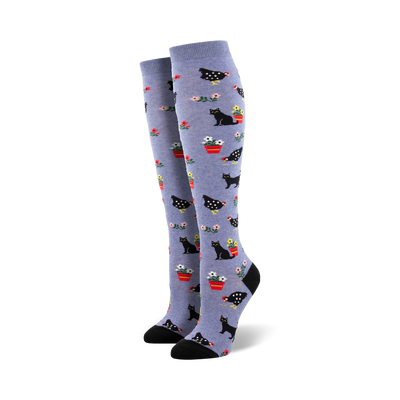 blue knee-high women's socks with a pattern of black cats and red chickens.  