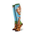 Pair of knee-high socks; light blue background, brown giraffes, green accents. Adult sized.