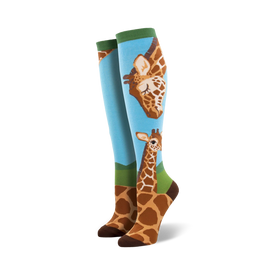 loving giraffes knee-high socks: charming blue background, green cuff, cute brown giraffe pattern, one large facing left, one smaller facing right, perfect for women's casual wear.   