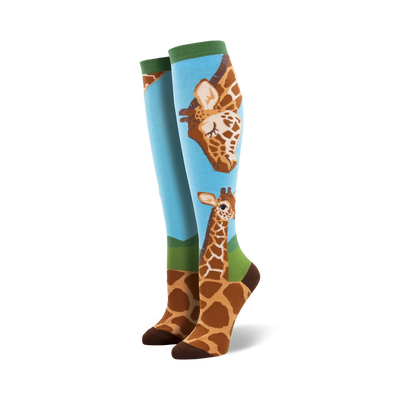 loving giraffes knee-high socks: charming blue background, green cuff, cute brown giraffe pattern, one large facing left, one smaller facing right, perfect for women's casual wear.   