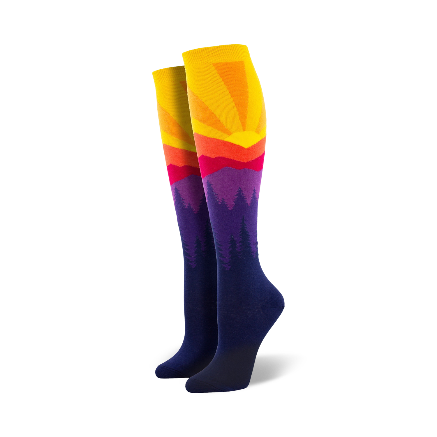 Pair of women's knee-high socks showcasing a vibrant sunset over silhouetted mountains. Colors include yellow, orange, red, purple, and navy blue.