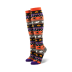 Pair of women's knee-high socks. Orange, gray, purple, and black stripes with pumpkins, ghosts, and witch hats.