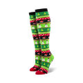 Pair of women's knee-high Christmas socks. Green, red, and black stripes with snowmen, Christmas trees, and candy cane designs.