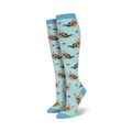 Pair of light blue knee-high socks featuring a repeating pattern of otters holding rocks, alongside starfish and seashells.