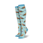 Pair of light blue knee-high socks featuring a repeating pattern of otters holding rocks, alongside starfish and seashells.