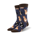 Close-up view of a pair of navy blue crew socks with a pattern of corgi butts. The socks have brown cuffs.