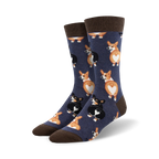 Close-up view of a pair of navy blue crew socks with a pattern of corgi butts. The socks have brown cuffs.