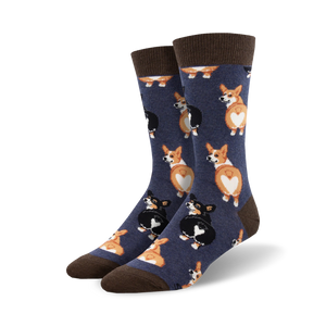 corgi butt socks are a pair of blue crew socks featuring a pattern of black and tan corgi butts facing upwards with heart-shaped white fur patches.   