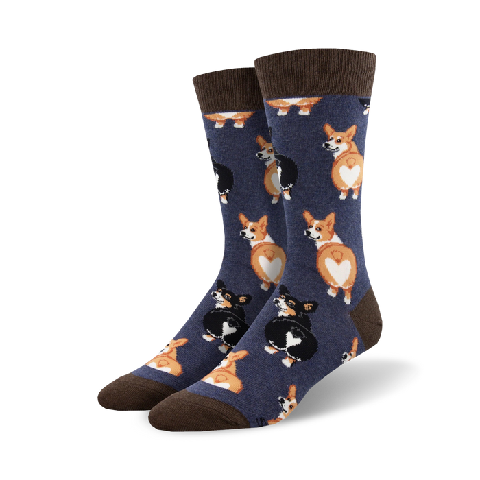 corgi butt socks are a pair of blue crew socks featuring a pattern of black and tan corgi butts facing upwards with heart-shaped white fur patches.   